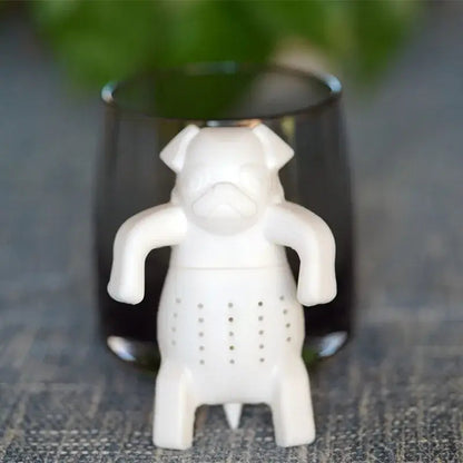 White dog tea infuser next to a teapot