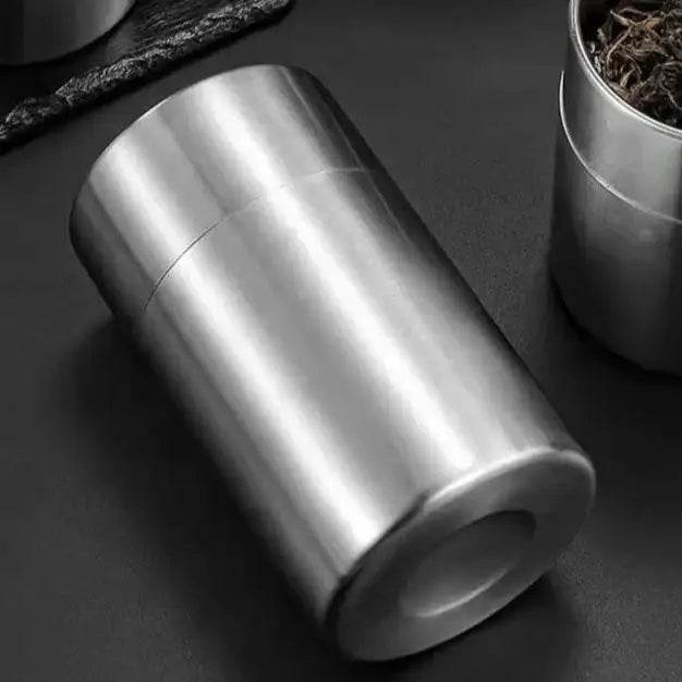 Airtight stainless steel tea canister showing inner and outer lid system