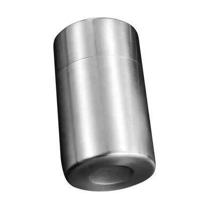 Double lid tea canister open, filled with loose leaf green tea