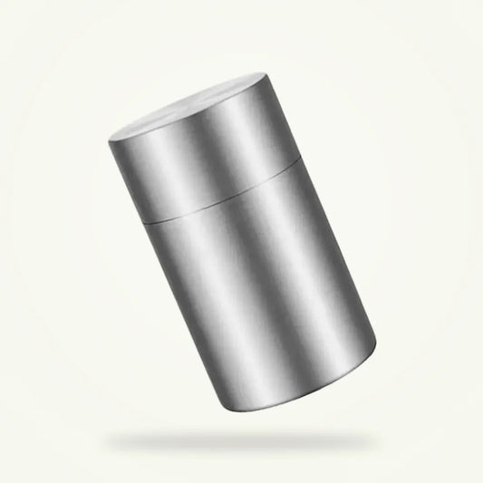 Double lid stainless steel tea canister 14x8x8cm on plain background