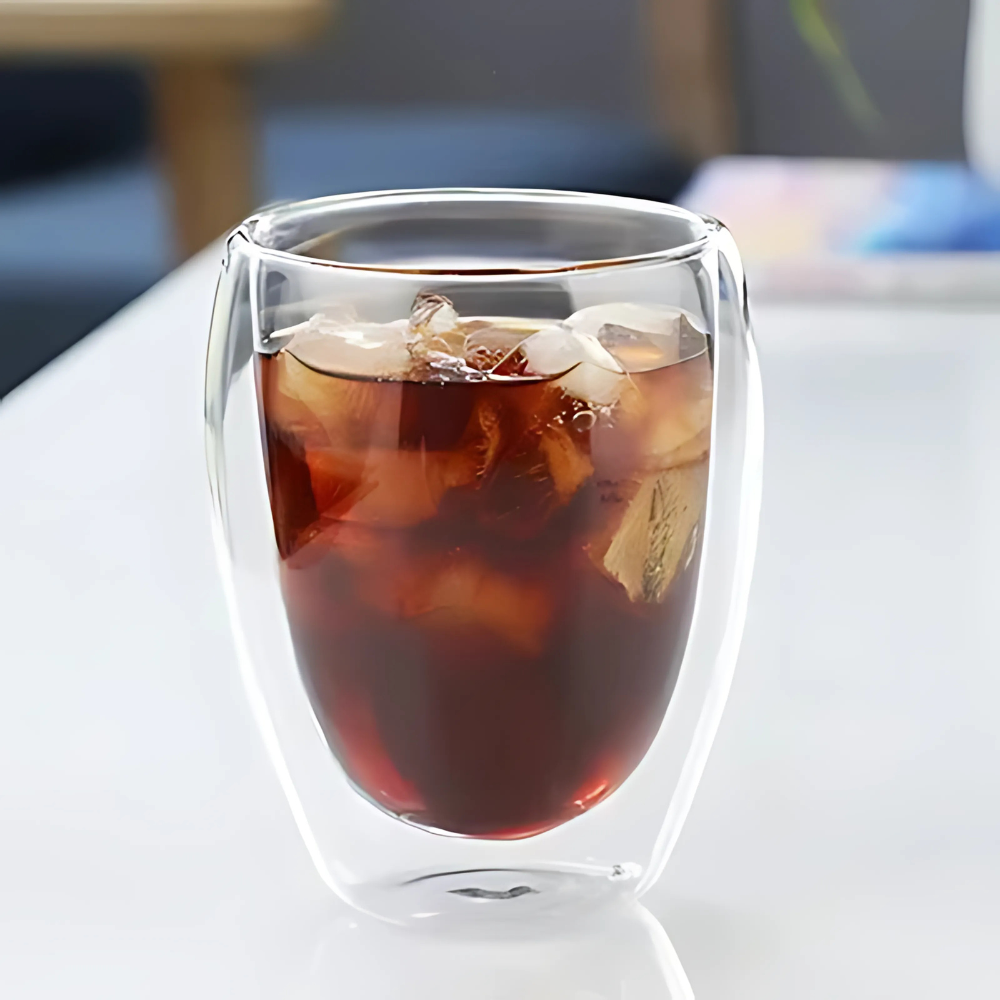 Hand holding a double wall glass tea cup, cool outer wall demonstration