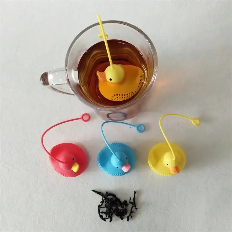 Duck tea infuser with a cup of tea and a book
