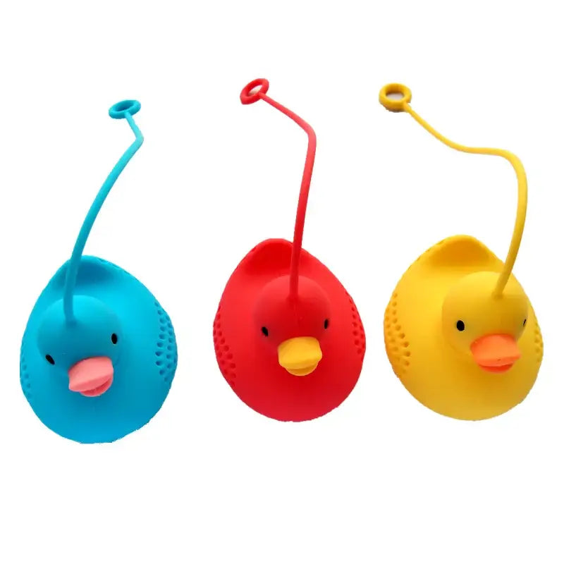 Duck tea infuser sitting on a saucer with tea leaves