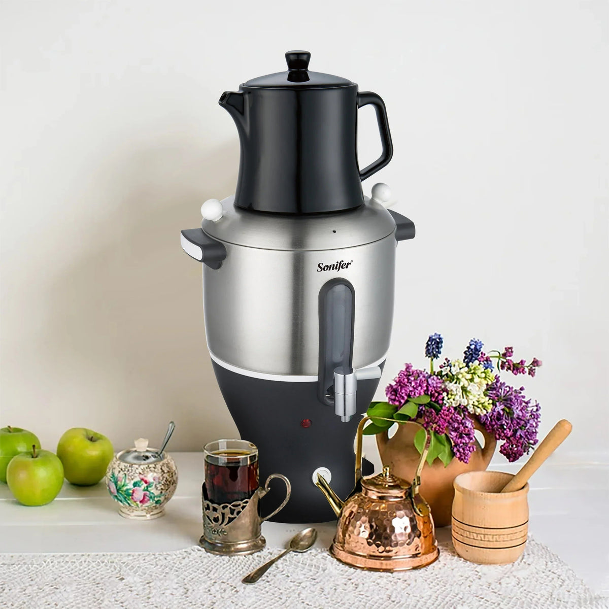 Close-up of black Turkish teapot resting on electric samovar base