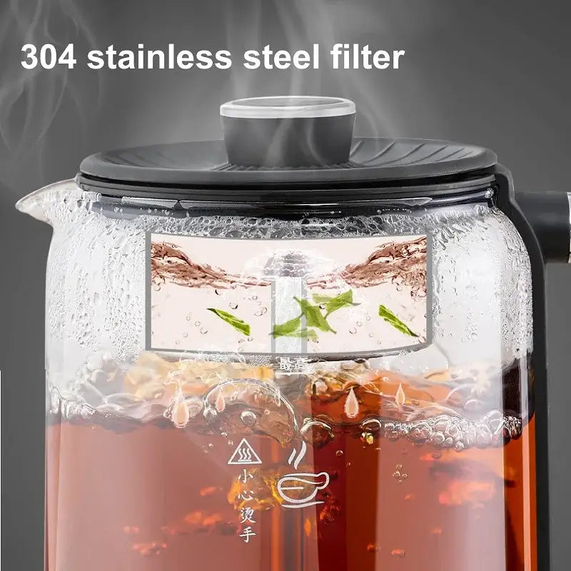 Electric tea maker on kitchen countertop with two filled teacups beside it