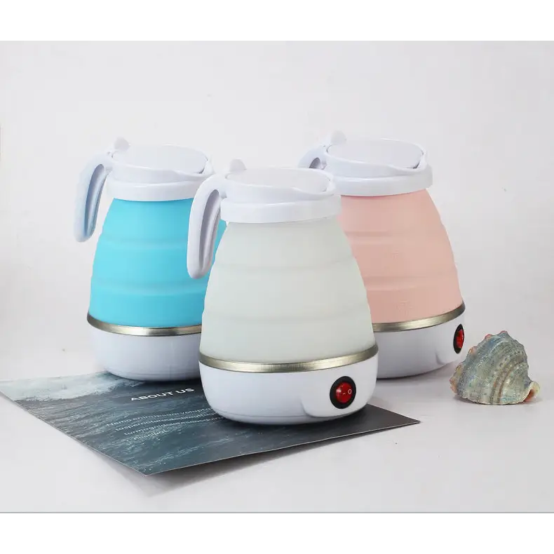 White glass electric kettle for hot water with steam rising from spout