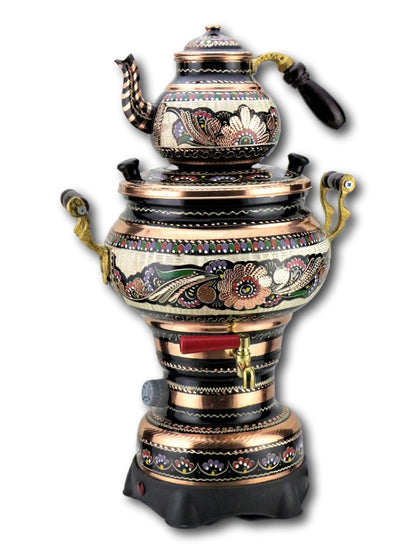 Turkish tea being poured from copper electric teapot into tulip glass