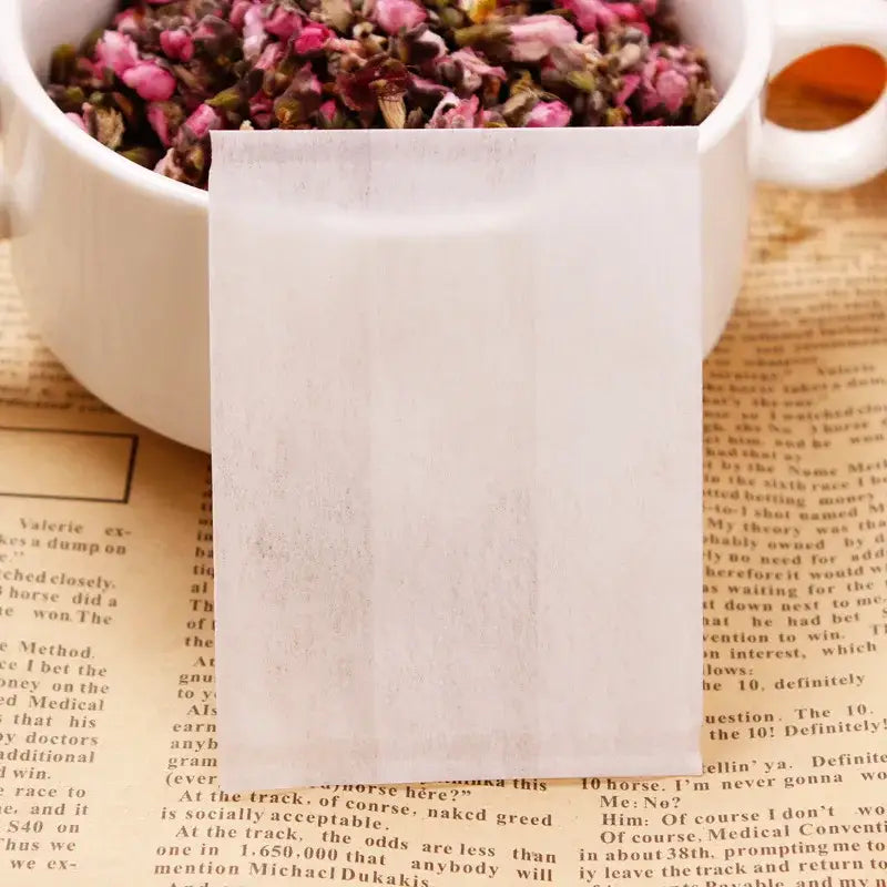 Tea bag filled with loose leaf tea, drawstring closed