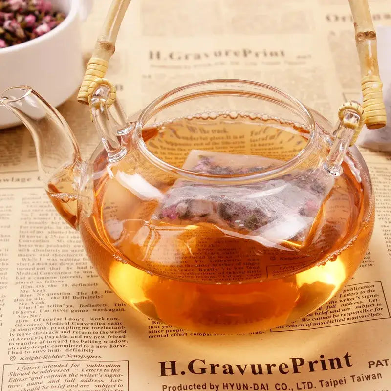 Steeping tea bag in a glass cup of hot water