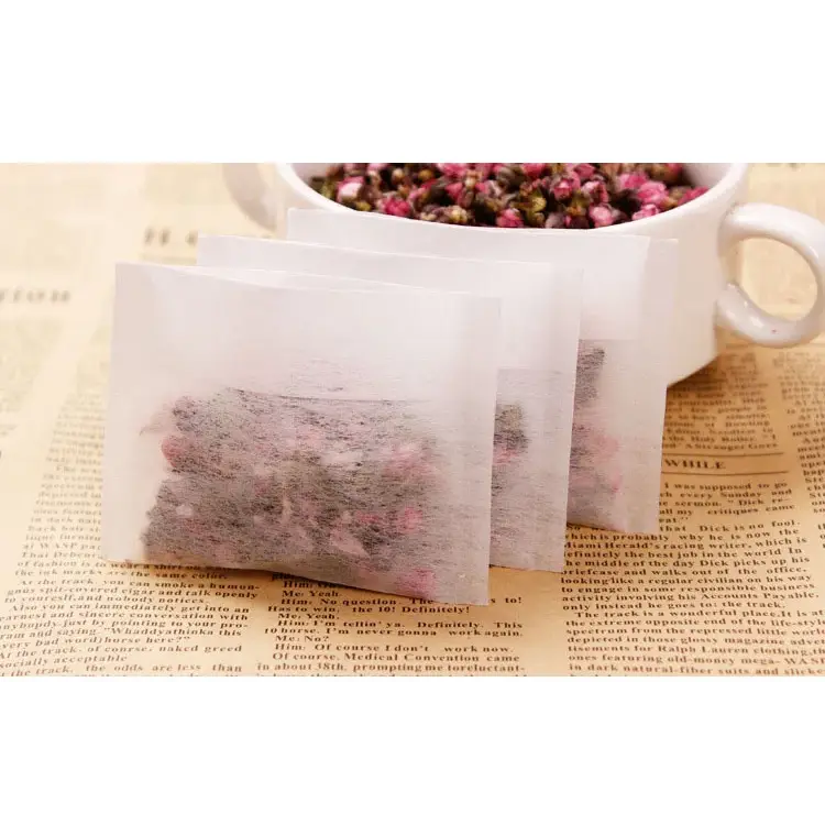 Empty tea bags laid out on a wooden table, natural light