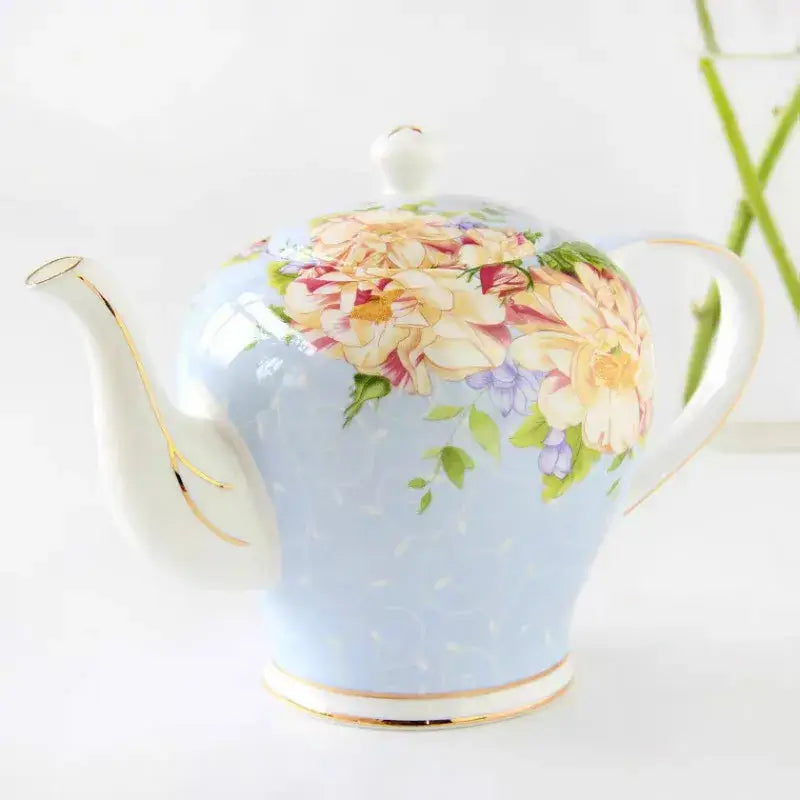 English ceramic teapot pouring tea into cup