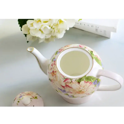 English ceramic teapot on kitchen counter with tea cups