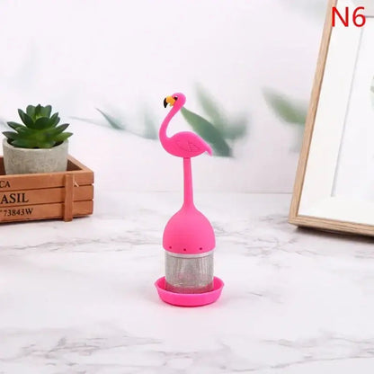 Flamingo tea infuser in pink silicone, floating in a mug of tea