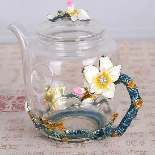 Glass teapot with blooming tea flower steeping inside