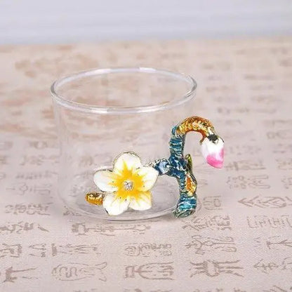 Small glass tea cup from floral teapot set close-up view