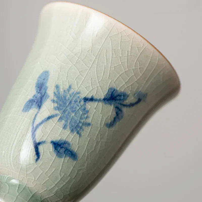 Four Gentlemen porcelain cups arranged on a tea tray with orchid and bamboo motifs visible