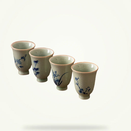 Four Gentlemen porcelain tea cups boxed set on plain background showing all four painted motifs