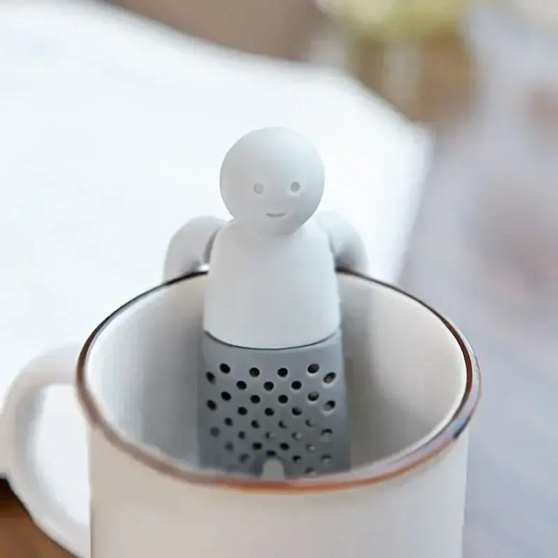 Funny little man silicone tea infuser on a mug