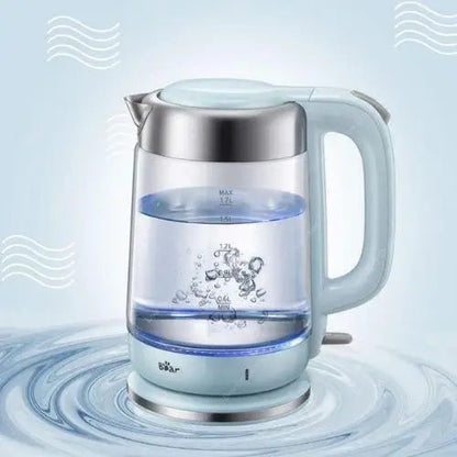 Pouring hot water from glass electric kettle into teacup