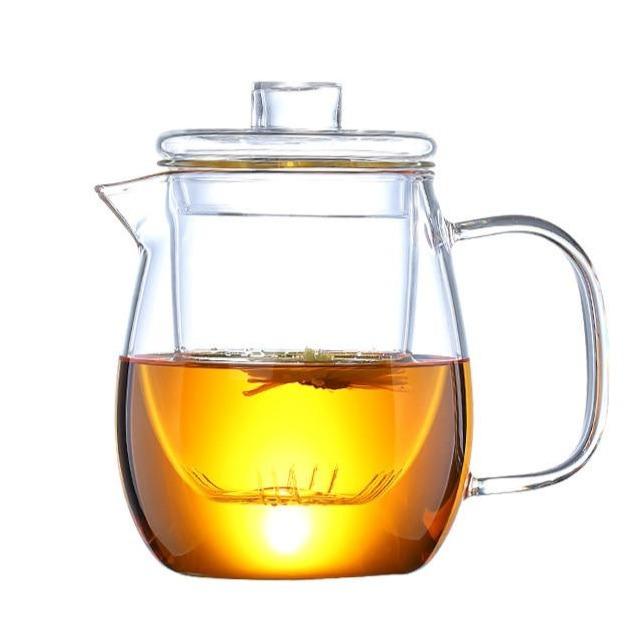 Flowering tea bundle blooming open inside Scandinavian glass teapot