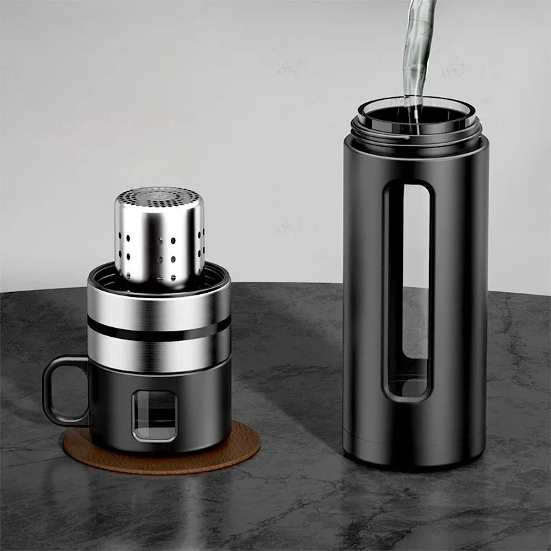 Glass tea infuser bottle filled with loose-leaf green tea leaves