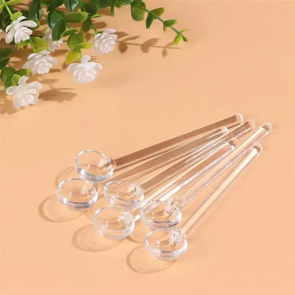 Glass tea spoon set with clear spoons on a wooden table