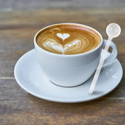 Elegant glass tea spoon with a cup of hot tea