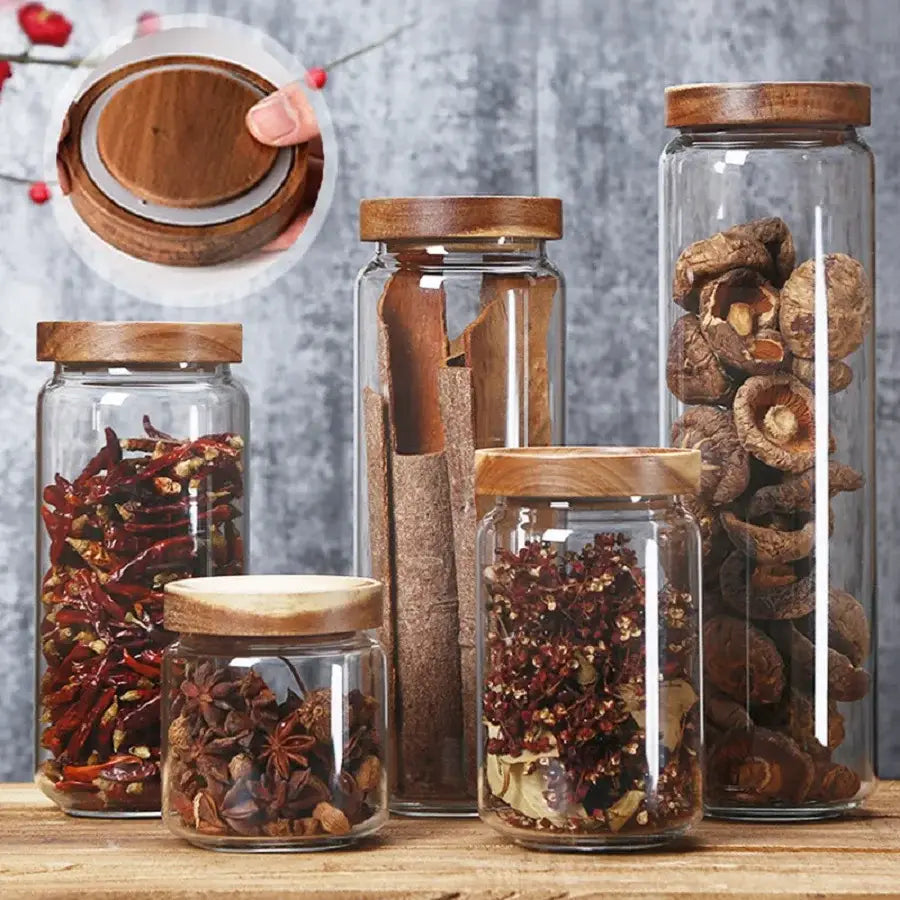 Airtight glass tea canister filled with loose leaf tea, bamboo lid open beside it
