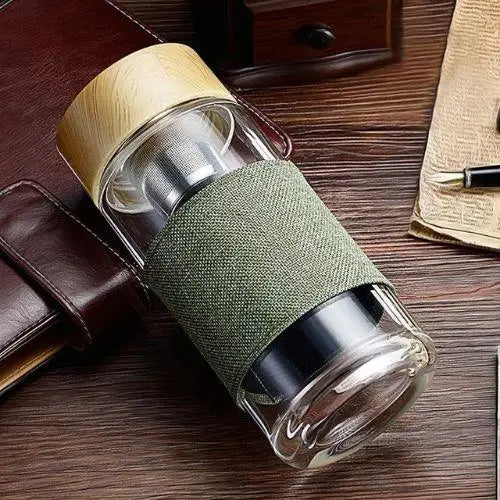 Using glass tea thermos bottle at office desk