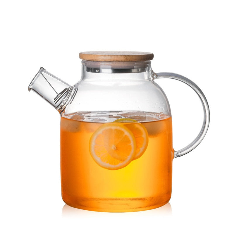 Blooming tea ball unfolding in hot water inside Scandinavian glass teapot