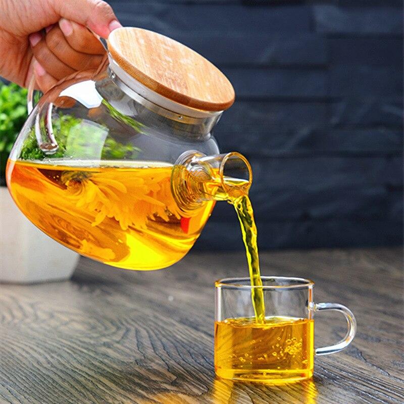 1800ml glass teapot for blooming tea with cup and saucer in bright morning light