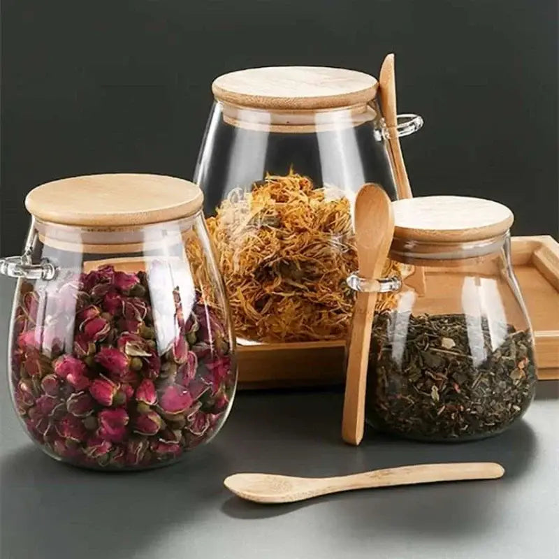Borosilicate glass teapot with bamboo lid on wooden table, warm kitchen setting
