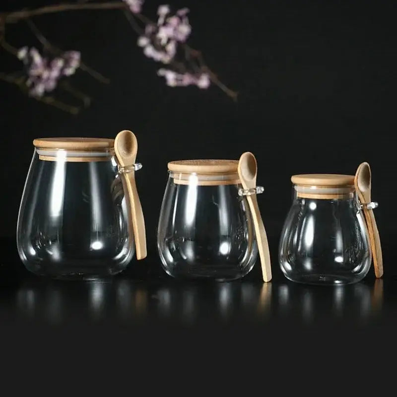 Glass teapot with removable infuser filled with loose-leaf green tea, bamboo lid to the side