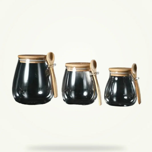 Glass teapot with bamboo lid and removable infuser, full product view on plain background