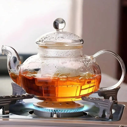 Pouring tea from glass teapot with built-in infuser