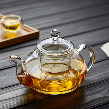 Glass teapot infuser basket removed showing loose leaf tea