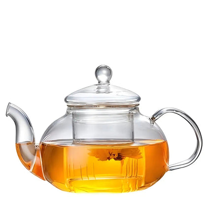 Glass teapot with infuser on cozy kitchen counter morning setup