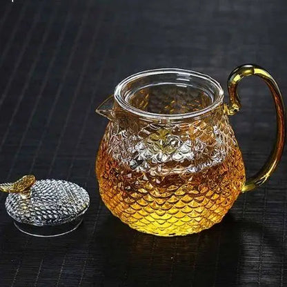 Glass teapot with built-in strainer being used to brew tea