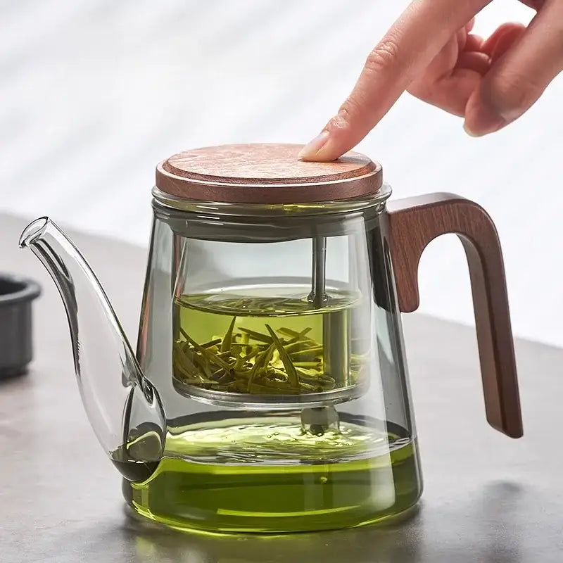 Close up of glass teapot infuser with tea leaves