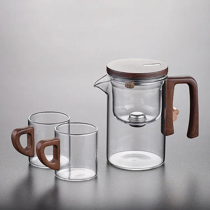 Glass teapot with infuser, on wooden table