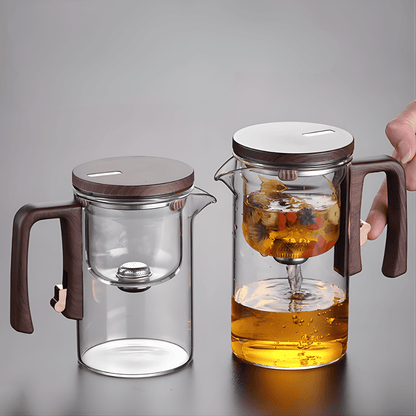 Glass teapot and cups set, top view showing open infuser basket and teapot lid