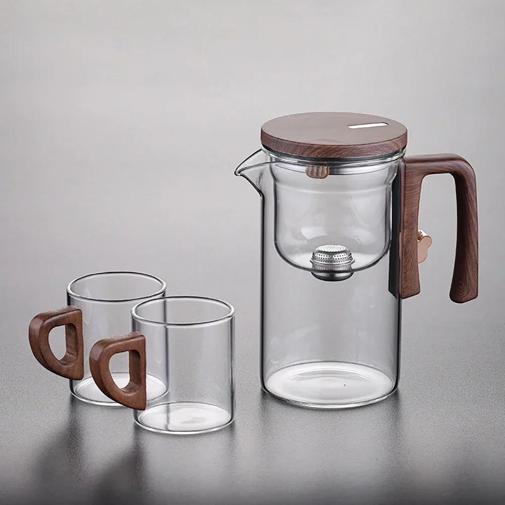 Loose-leaf tea steeping inside glass teapot with magnetic infuser, leaves visible through glass