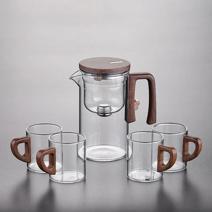 Clean empty glass teapot with removable magnetic infuser beside it, ready to use
