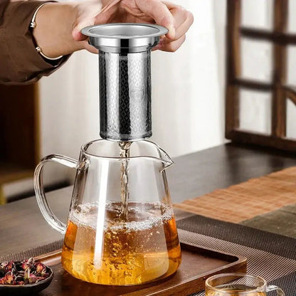 Glass teapot with tea leaves in infuser