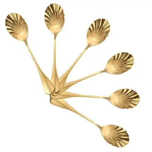 Gold stainless steel tea spoons with scallop shell design close-up