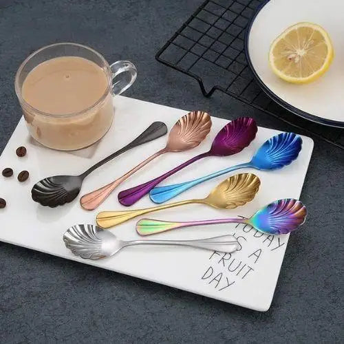 Single gold stainless steel teaspoon showing shell bowl detail