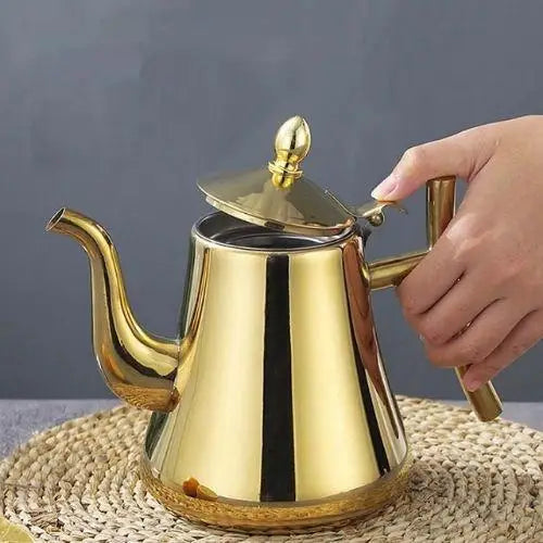 Gold teapot lid open showing removable mesh infuser basket inside