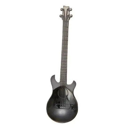 Black guitar tea spoon on wooden table