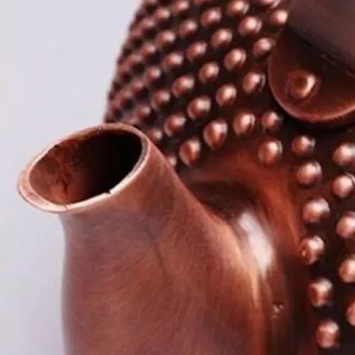 Copper teapot spout close up
