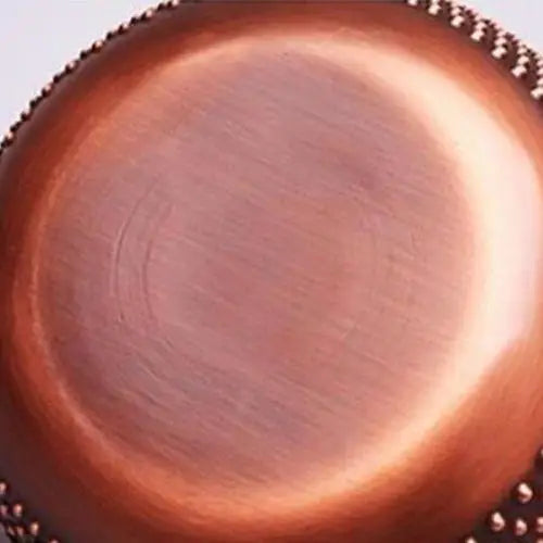 Bottom of copper teapot showing copper
